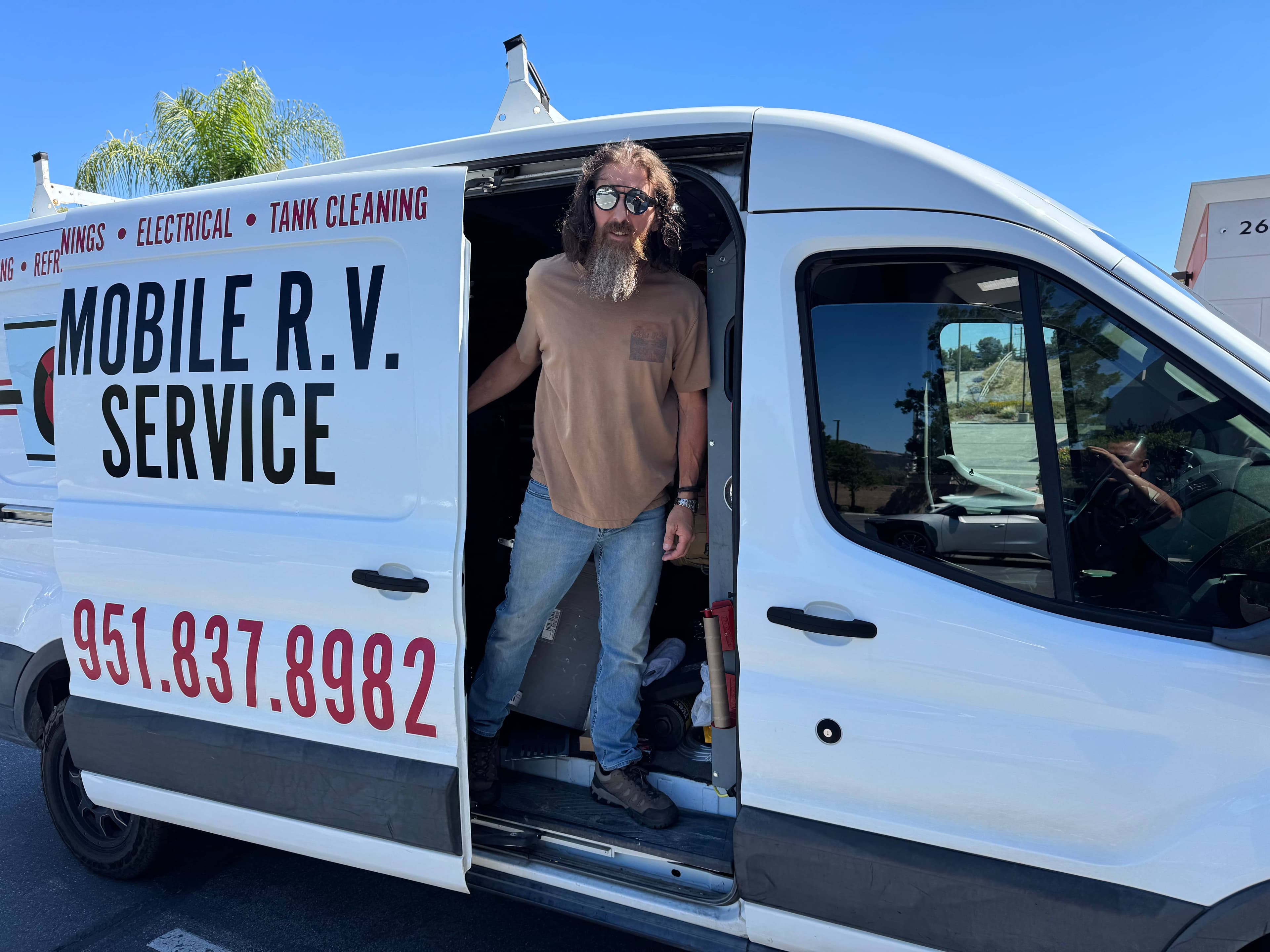 CD Mobile RV van and owner standing at the door